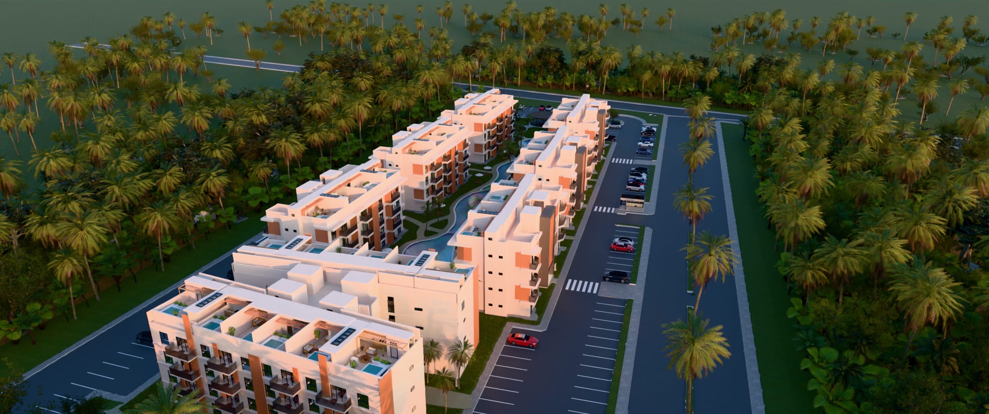 Aerial view of LIORA at dusk: low white buildings among tropical gardens and the lagoon pool